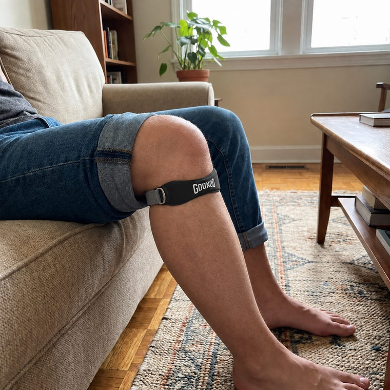 The slim knee strap sitting just below the kneecap, feet up on the sofa