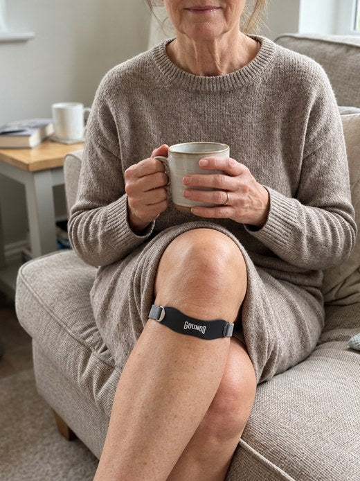 Customer pointing at the June Strap on the sofa